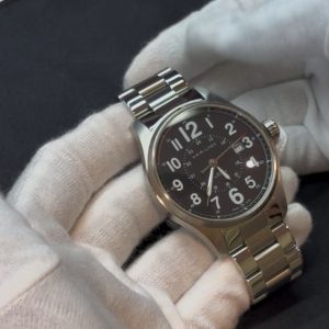 白手袋で中古時計のケース・文字盤・針を確認している様子